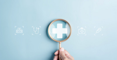 A picture of a magnifying glass being held over medical symbols